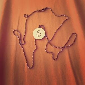 Silver necklace with "S" on it