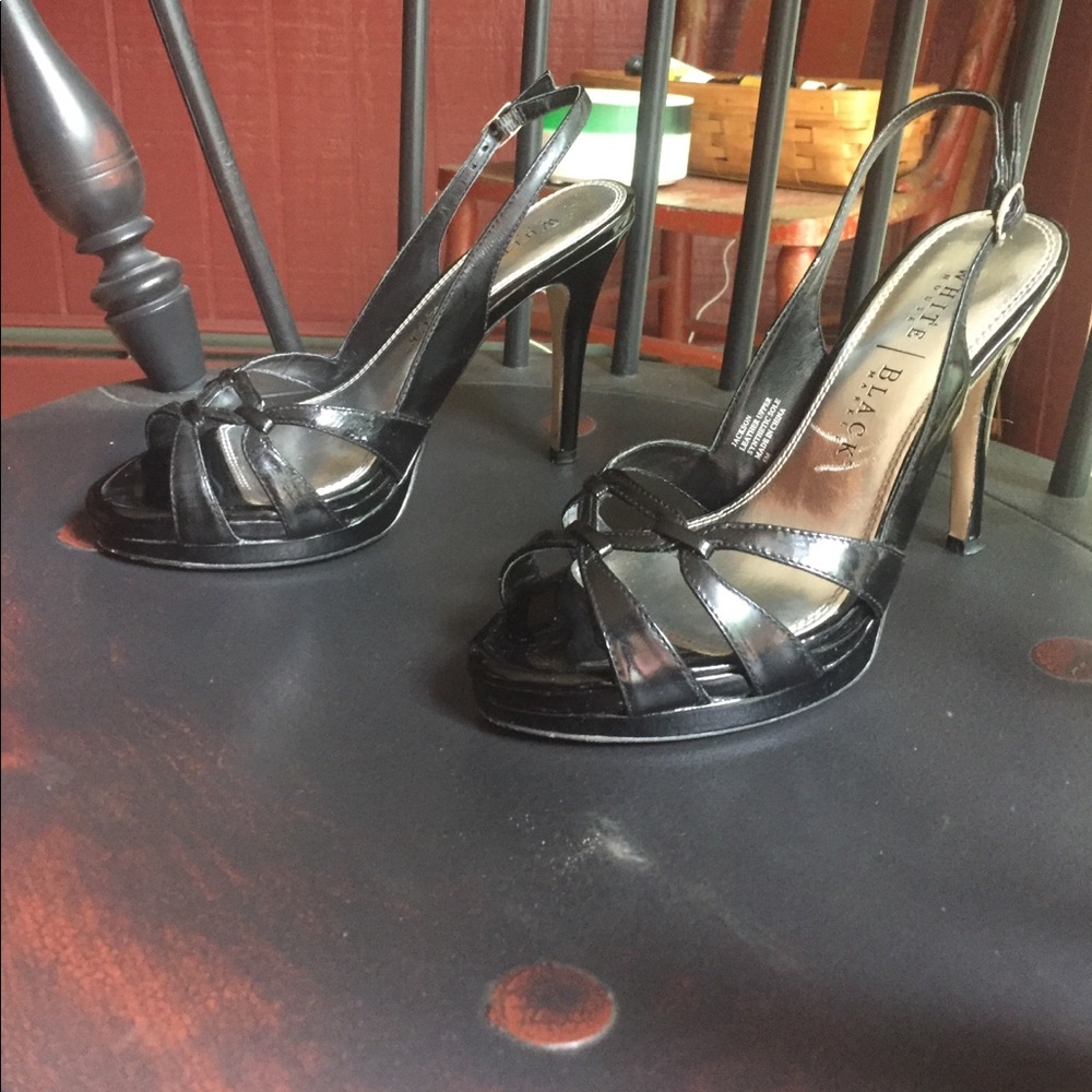 A gently used pair of high heel black sandals