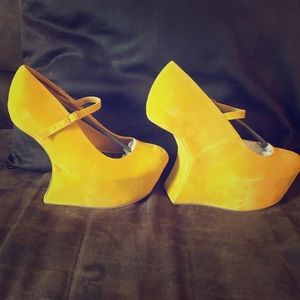 Mustard colored heel less shoes.