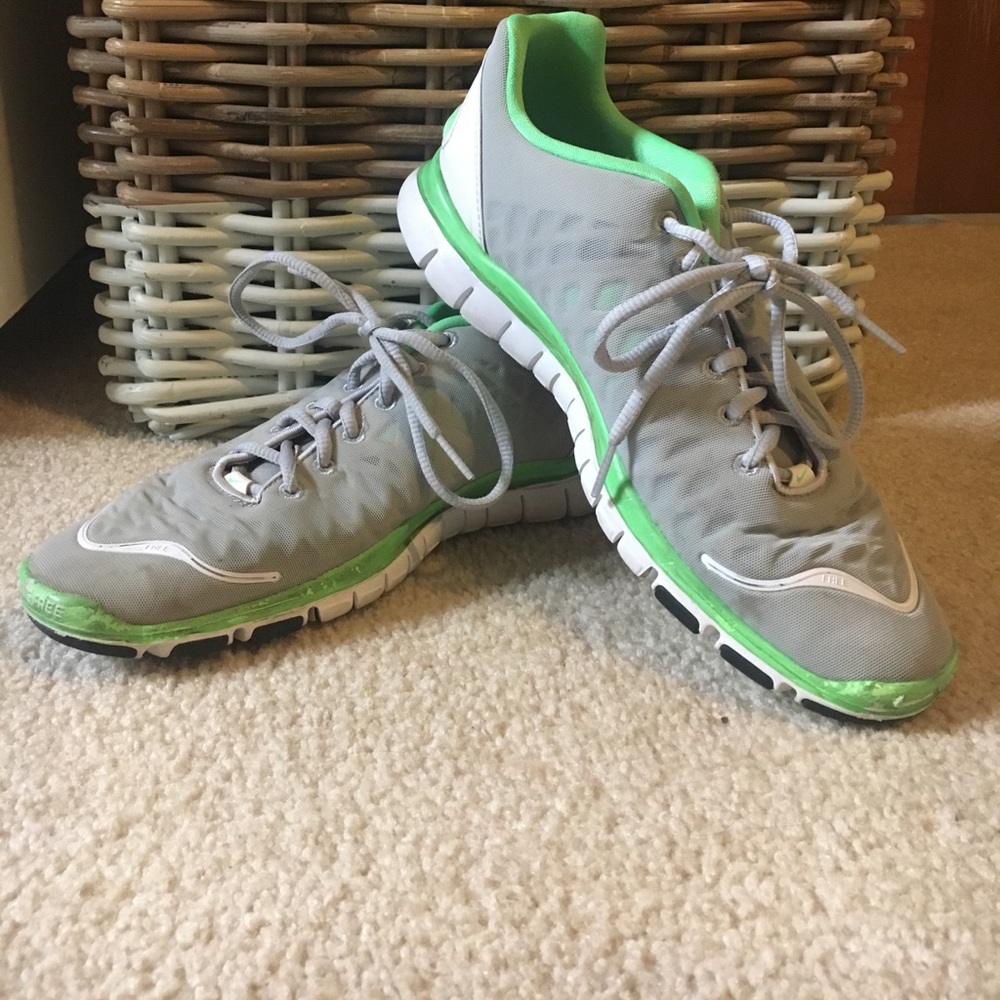 Grey Nike shoes with green accents