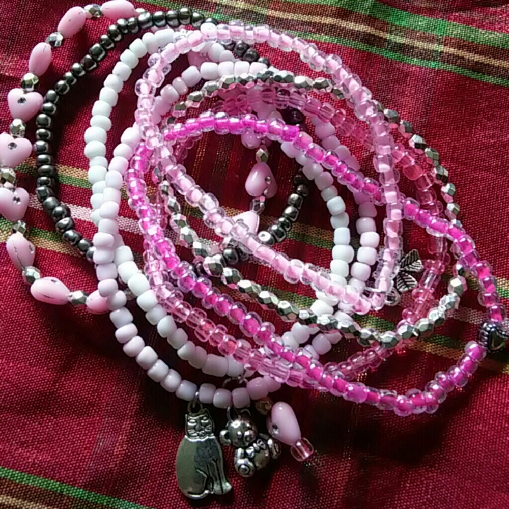 Stacked stretch bracelets with charms
