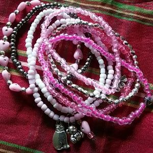 Stacked stretch bracelets with charms