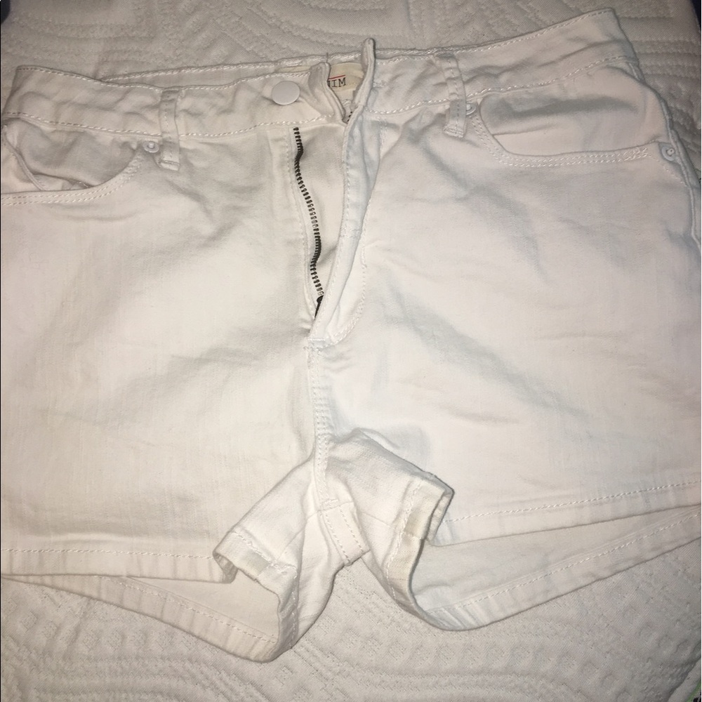 a pair of white denim shorts