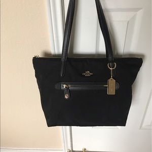 Gently used black Coach tote with leather straps