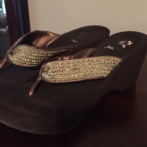 Brown heeled flip flops with gold sparkly straps