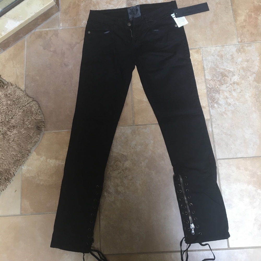 black jeans with laces and a zipper at the bottom