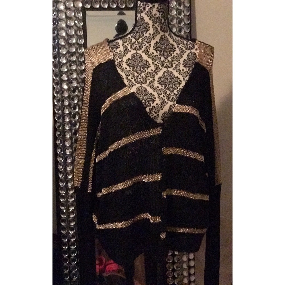 Loose fit black and gold sweater.