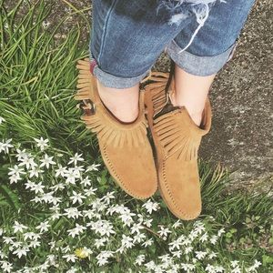 Tan Minnetonka moccasins with feather detail