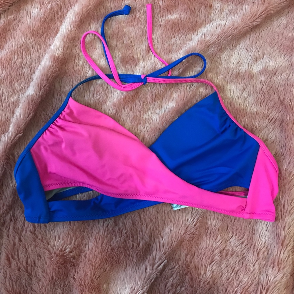 Bright pink and blue cross vs swim suit