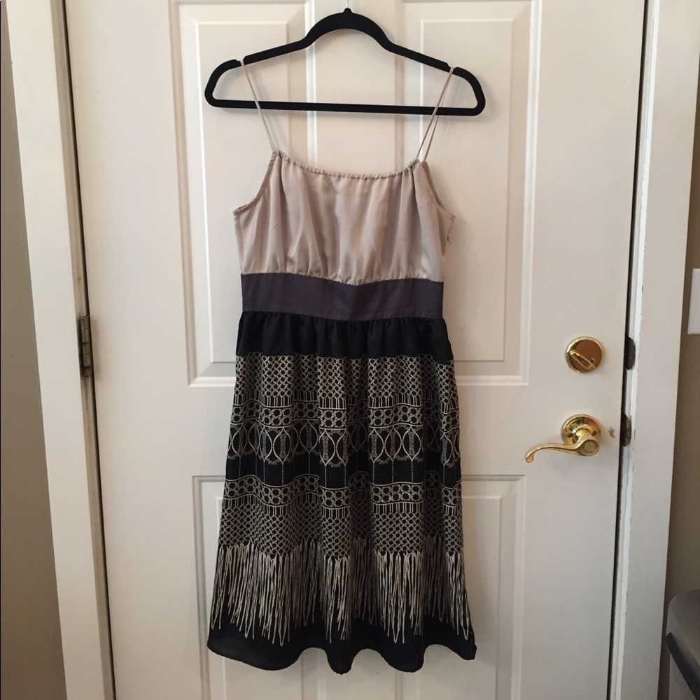 Polyester, knee length, spaghetti strap dress.