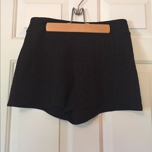 Black, high-waisted fabric shorts.