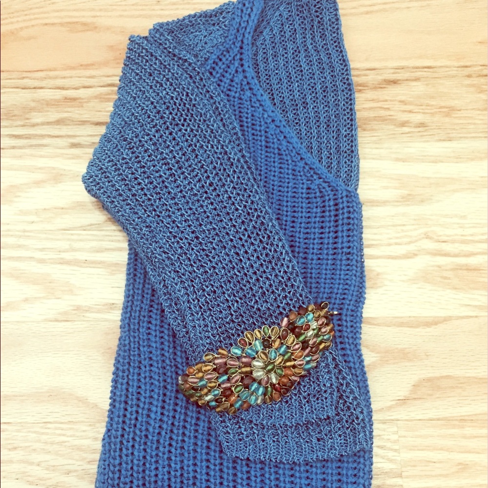 Royal blue , thick knit v-neck sweater .