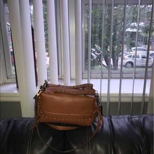 A women's rust colored handbag. Very gentle worn.
