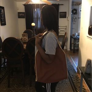 Women's studded rust colored shoulder bag