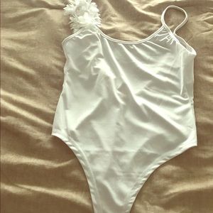 White swimsuit with one floral strap