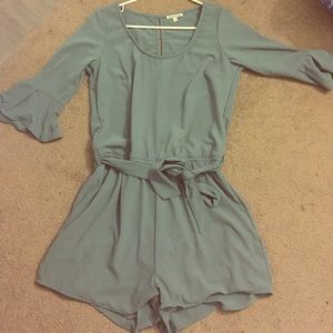Light blue romper with bell sleeve and a waist tie