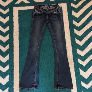 Boot cut jeans with embellishments on the pockets