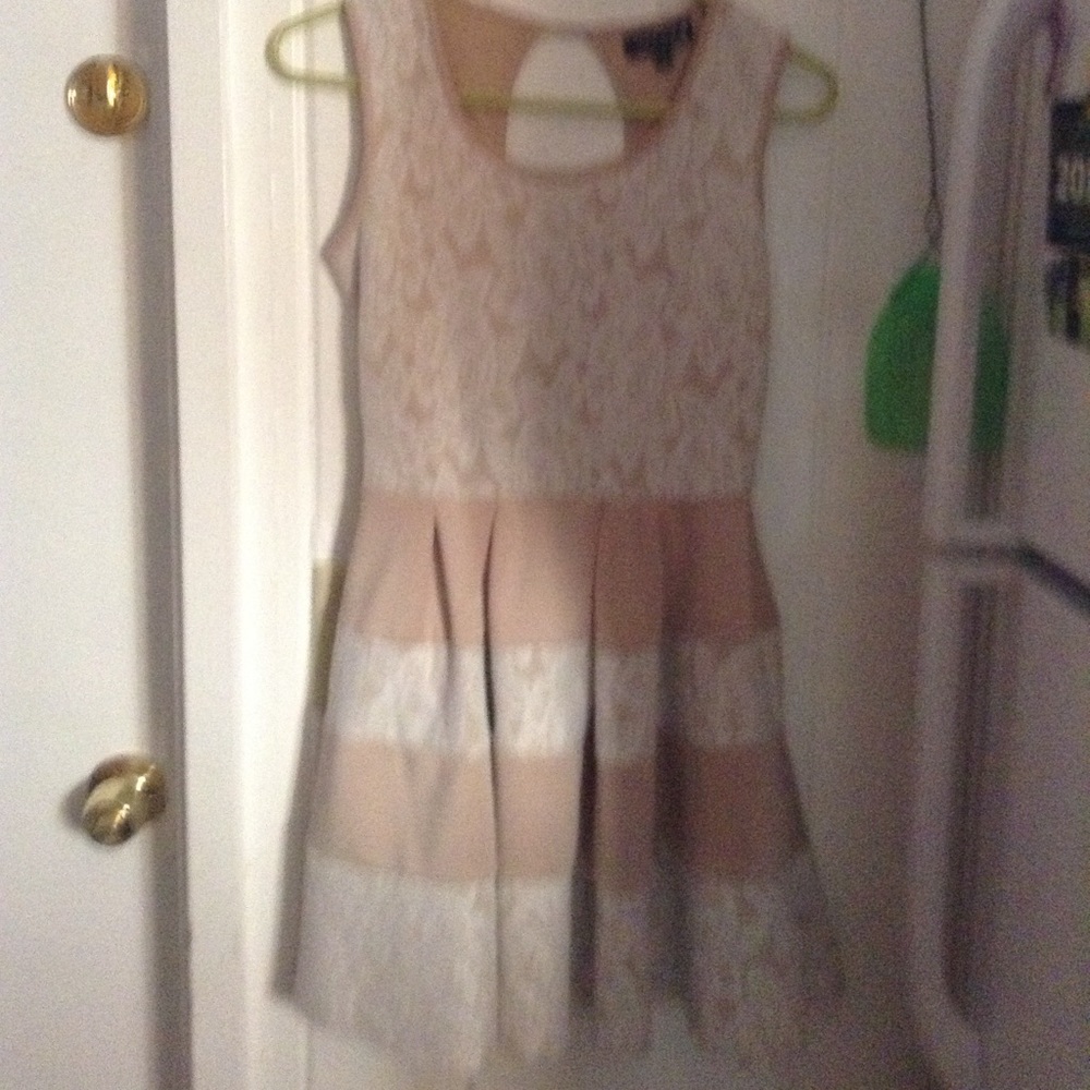 A tan dress with lace flower