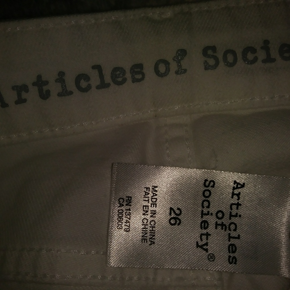 White long capri pants with holes in legs in style