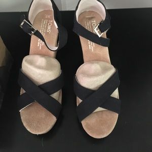Brand new, still in box. Toms black wedges