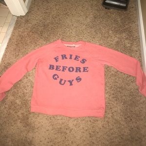 A light pink colored long sleeved shirt.