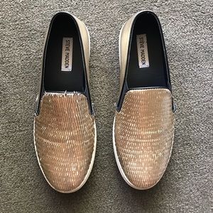 Steve Madden gold slip-ons.