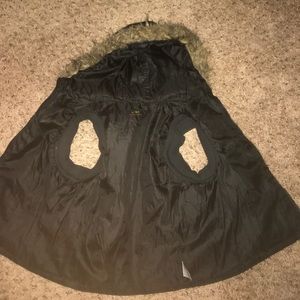 A black sleeveless vest with fur on the hood.