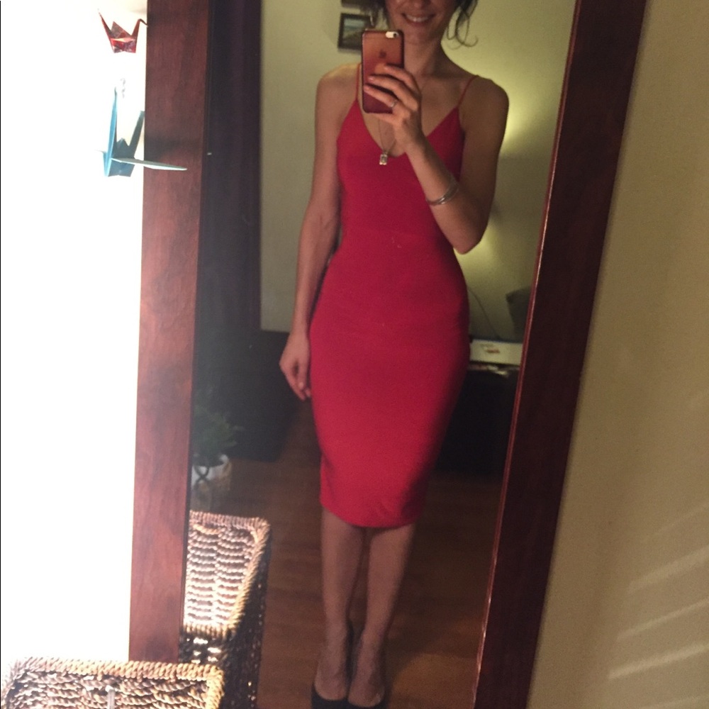 Dark red body fitting dress.