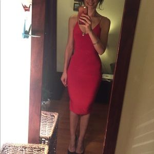 Dark red body fitting dress.