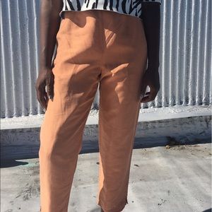 Peach silk slacks.
