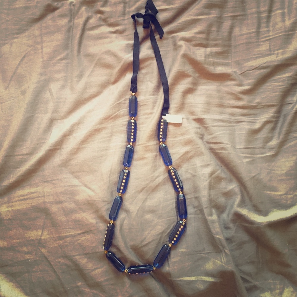 Blue plastic and rhinestone necklace on ribbon
