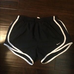 Navy blue and white Nike running shorts