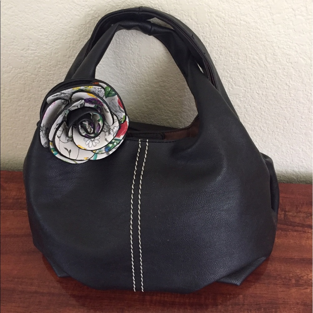 Black handbag with flower accessory