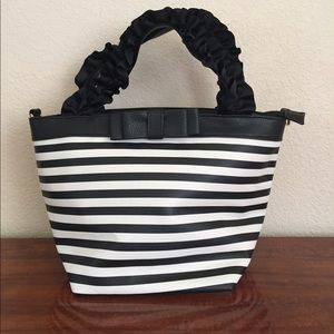 Black and white striped ruffle handle bag