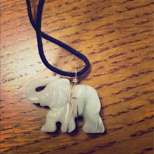 Ivory elephant necklace on a black cord