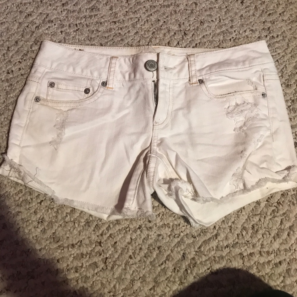 Distressed white jean shorts