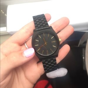 Black and gold Nixon Watch