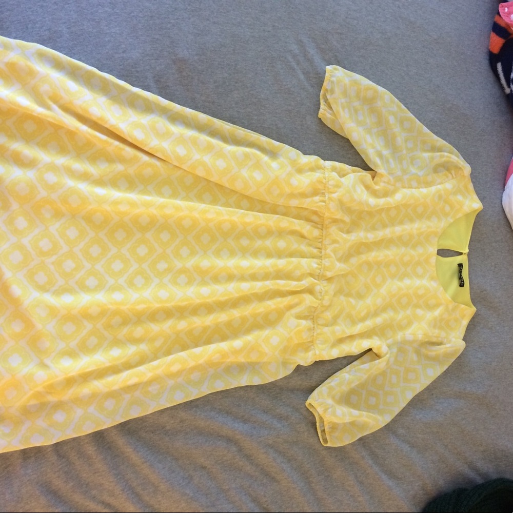 Mid-length yellow patterned dress.
