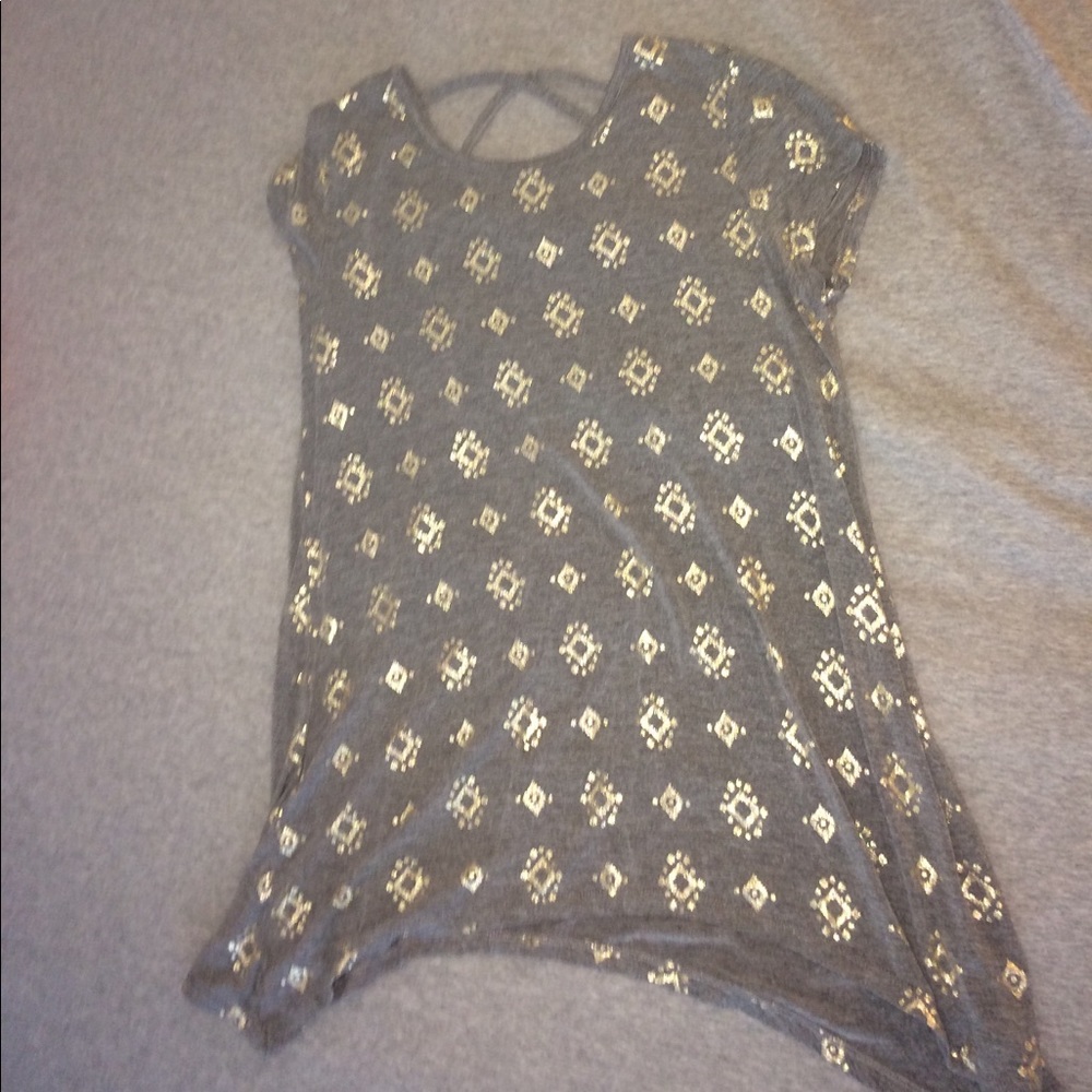 Grey shirt with a gold design all over it.