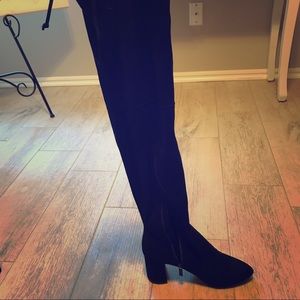 Black over-the-knee boots.