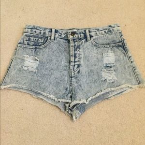Worn out light denim shorts