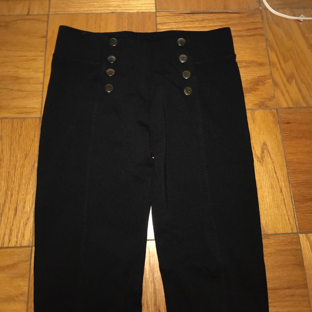 High-waisted black tight pants with buttons