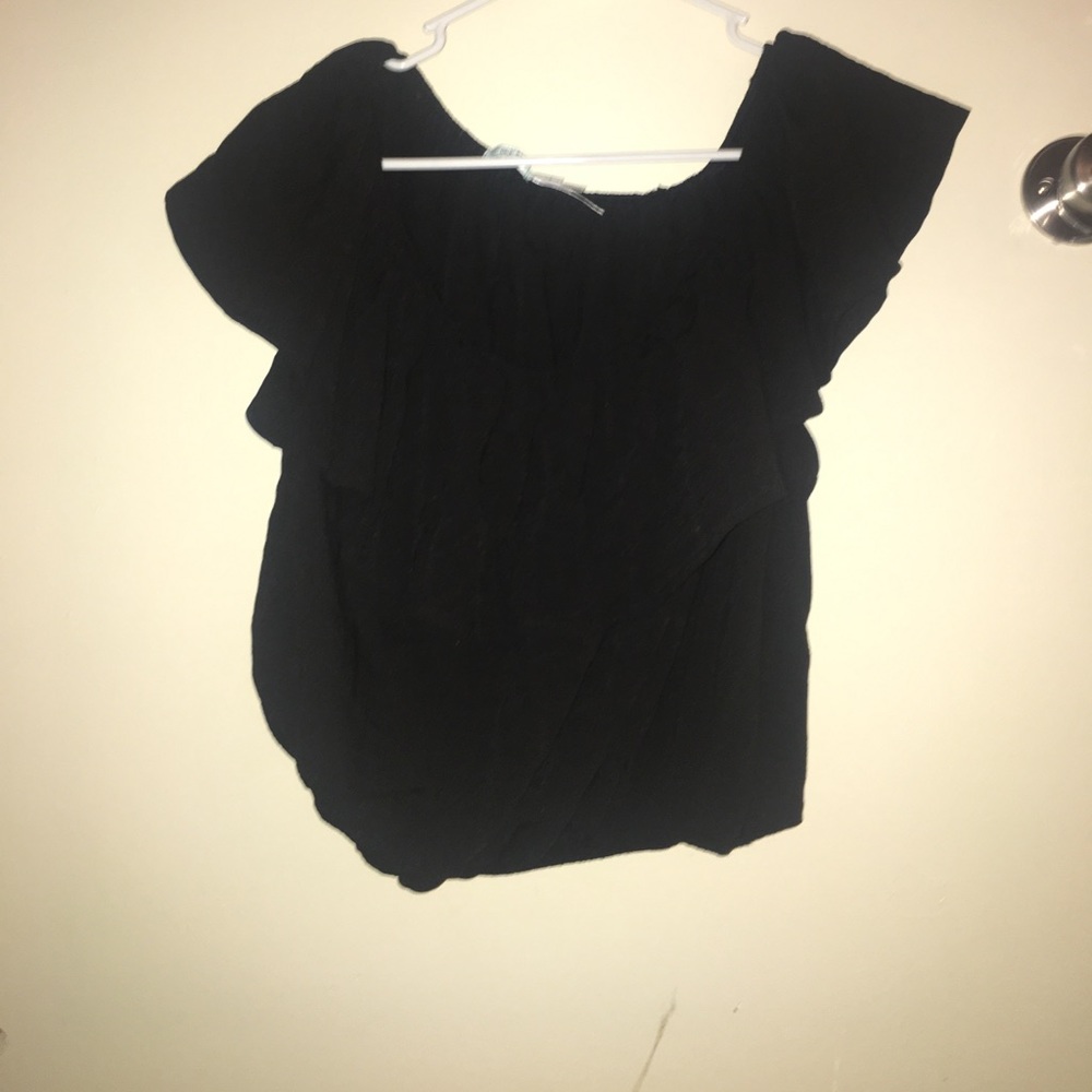 Black crop top. Off the shoulders.