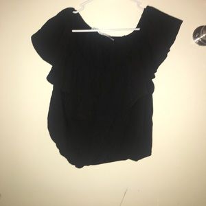 Black crop top. Off the shoulders.