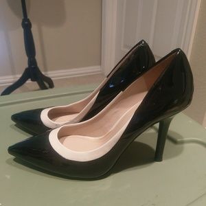 Black patent leather pumps with white trim.