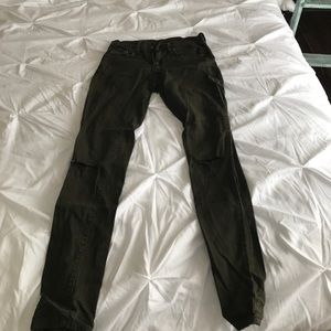 Olive colored jeans with ripped knees
