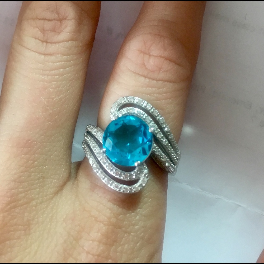 Blue and white sapphire swirl ring