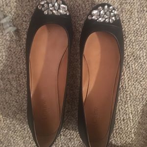 Black leather flats with decorative toe