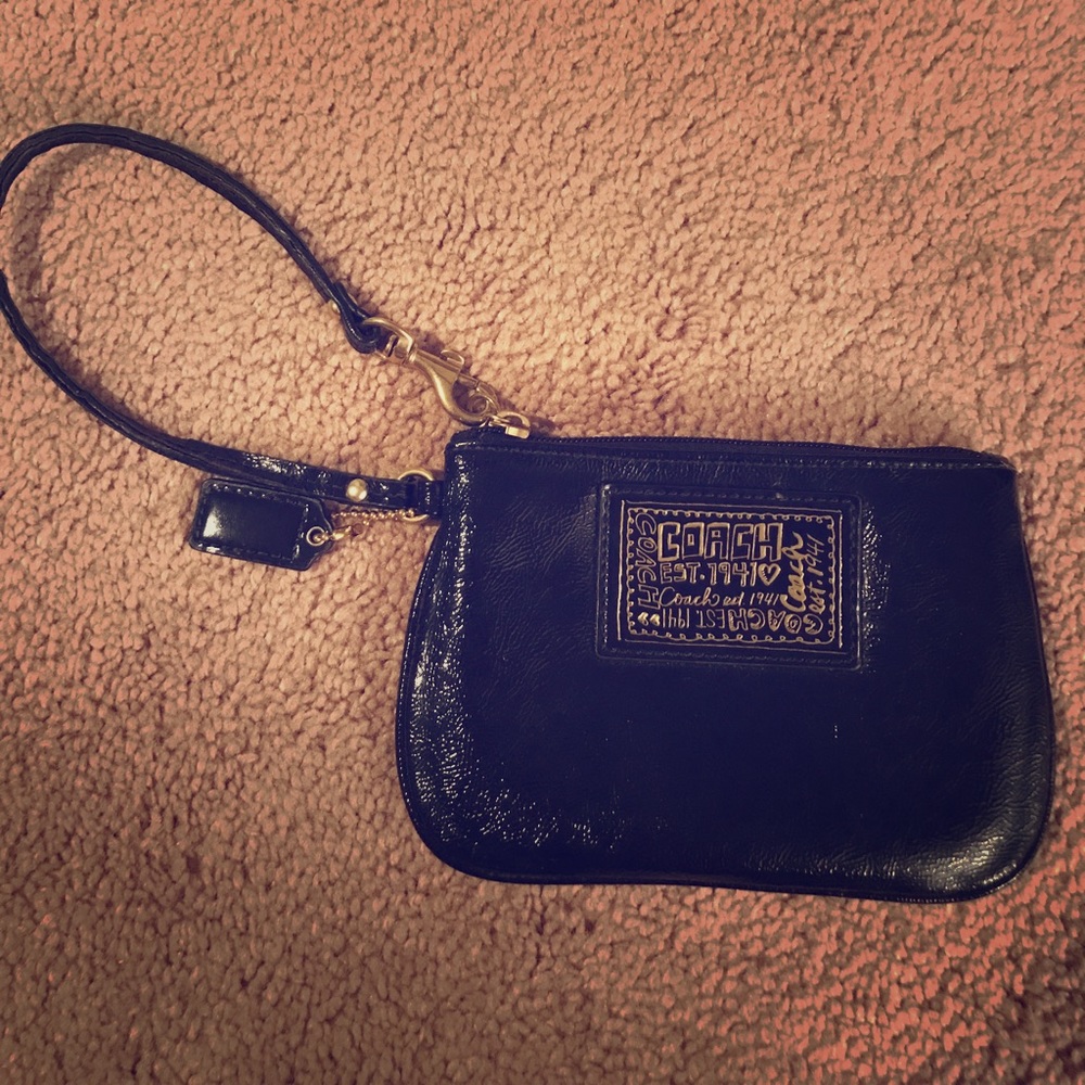 Black and gold COACH wristlet
