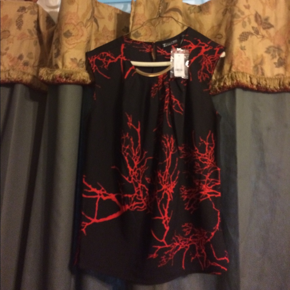 NY&C black blouse with splashes of red.